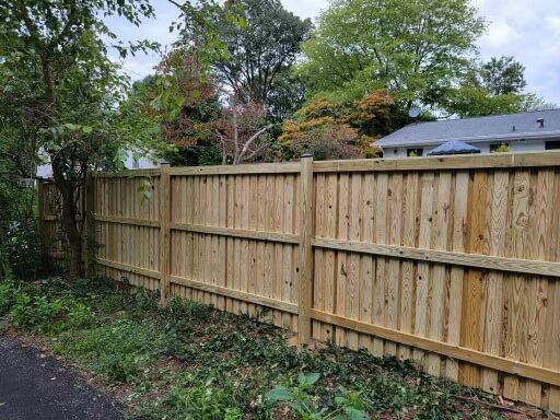 a wooden fence in front of a house