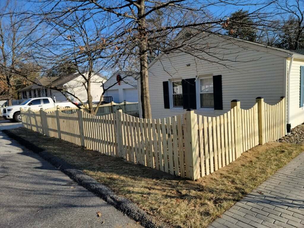 a house with a white picket fence in front of it