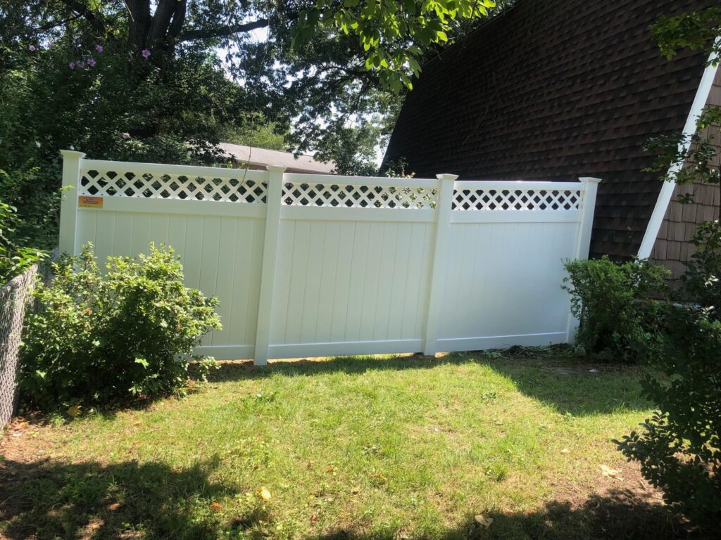 a white fence in front of a house