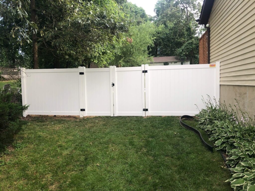 a white fence with black trim around it